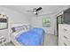 This bedroom has a queen sized bed, ceiling fan and sliding door to the outside at 10100 Sailwinds N Blvd # 203, Largo, FL 33773