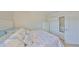 This bedroom boasts comfortable bedding, closet, and a door to the rest of the home at 10100 Sailwinds N Blvd # 203, Largo, FL 33773