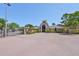 Elegant community entrance with brick drive and lush landscaping at 10100 Sailwinds N Blvd # 203, Largo, FL 33773