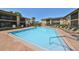 Large community pool with lounge chairs, palm trees, and nearby clubhouse at 10100 Sailwinds N Blvd # 203, Largo, FL 33773