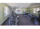 Bright fitness center with multiple machines, rubber flooring, and large windows for a comfortable workout experience at 10100 Sailwinds N Blvd # 203, Largo, FL 33773