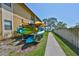 Outdoor kayak storage rack with colorful kayaks next to a walkway and a view of the lake at 10100 Sailwinds N Blvd # 203, Largo, FL 33773