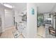 Bright kitchen with white cabinetry and granite countertops, open to a cozy living room at 10100 Sailwinds N Blvd # 203, Largo, FL 33773