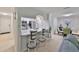 Modern kitchen with stainless steel appliances, breakfast bar and adjacent dining area at 10100 Sailwinds N Blvd # 203, Largo, FL 33773