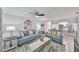 Cozy living room with light blue sofas and access to the breakfast bar and kitchen at 10100 Sailwinds N Blvd # 203, Largo, FL 33773