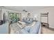 Inviting living room with stylish decor and access to a screened-in patio at 10100 Sailwinds N Blvd # 203, Largo, FL 33773