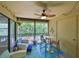 Screened in back porch with a table, chairs, and ceiling fan at 10100 Sailwinds N Blvd # 203, Largo, FL 33773