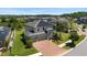 Scenic aerial shot of a two-story home featuring solar panels, a three-car garage, and verdant landscaping at 10712 Pleasant Knoll Dr, Tampa, FL 33647
