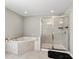 Beautiful bathroom featuring a soaking tub and glass shower with modern fixtures and tile at 10712 Pleasant Knoll Dr, Tampa, FL 33647