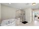 Beautiful bathroom featuring a soaking tub and glass shower with modern fixtures and tile at 10712 Pleasant Knoll Dr, Tampa, FL 33647