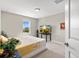 Bright bedroom featuring neutral walls, carpet flooring, and a window for natural light at 10712 Pleasant Knoll Dr, Tampa, FL 33647