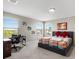 Well-lit bedroom with a desk, large windows, and stylish decor offering a cozy and inviting atmosphere at 10712 Pleasant Knoll Dr, Tampa, FL 33647