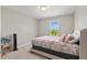 Cozy bedroom featuring a large window, neutral color, and carpet flooring at 10712 Pleasant Knoll Dr, Tampa, FL 33647