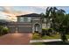 Beautiful two-story home with a three-car garage, brick driveway, and well-maintained landscaping at 10712 Pleasant Knoll Dr, Tampa, FL 33647