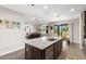 Modern kitchen featuring granite countertops, a large island, and seamless flow to living areas at 10712 Pleasant Knoll Dr, Tampa, FL 33647