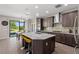 Modern kitchen featuring granite countertops, a large island, stainless steel appliances, and a breakfast bar at 10712 Pleasant Knoll Dr, Tampa, FL 33647