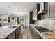 Modern kitchen with granite countertops, stainless steel appliances, and stylish backsplash at 10712 Pleasant Knoll Dr, Tampa, FL 33647