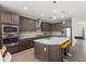 Modern kitchen with stainless steel appliances, granite countertops, and a breakfast bar at 10712 Pleasant Knoll Dr, Tampa, FL 33647