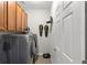Laundry room includes cabinets above the washer and dryer, and a clean white door at 10712 Pleasant Knoll Dr, Tampa, FL 33647