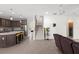 Open-concept living area with a kitchen, stairs, and comfortable leather seating at 10712 Pleasant Knoll Dr, Tampa, FL 33647