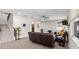 Spacious living room features a projector, tile floors, ceiling fan, and comfortable leather seating at 10712 Pleasant Knoll Dr, Tampa, FL 33647