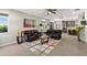 Open-concept living room with a view to the kitchen and comfortable leather sofas at 10712 Pleasant Knoll Dr, Tampa, FL 33647