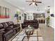 Bright open-concept living room with a kitchen, ceiling fan, and comfortable seating at 10712 Pleasant Knoll Dr, Tampa, FL 33647