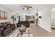 Bright open-concept living room with a kitchen, ceiling fan, and comfortable seating at 10712 Pleasant Knoll Dr, Tampa, FL 33647