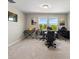 Large loft featuring neutral paint, carpet, and ample natural light from the large windows at 10712 Pleasant Knoll Dr, Tampa, FL 33647
