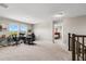 Bright loft space with neutral carpeting, offering versatile use as an office or play area with natural light at 10712 Pleasant Knoll Dr, Tampa, FL 33647
