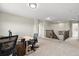 Spacious carpeted loft with multiple desks, offering an open workspace and access to other areas at 10712 Pleasant Knoll Dr, Tampa, FL 33647