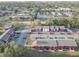 Aerial view of red and gray townhomes with ample parking, landscaping and mature shade trees in a serene neighborhood setting at 1095 82Nd N Ter # 1095A, St Petersburg, FL 33702