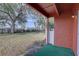 View of backyard from brick enclosed patio with white fence and mature trees at 1095 82Nd N Ter # 1095A, St Petersburg, FL 33702