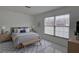 Cozy bedroom with large windows, a comfortable bed, and stylish decor at 1095 82Nd N Ter # 1095A, St Petersburg, FL 33702