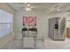 Bright dining area features a glass table, white chairs, and stainless steel refrigerator at 1095 82Nd N Ter # 1095A, St Petersburg, FL 33702