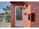 Close-up of a condo entrance with a screen door, individual mailboxes, and well maintained red brick at 1095 82Nd N Ter # 1095A, St Petersburg, FL 33702