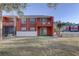View of brick two-story condo with enclosed patio, balcony and well maintained lawn at 1095 82Nd N Ter # 1095A, St Petersburg, FL 33702