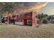 View of brick two-story condo with enclosed patio, balcony, well maintained lawn and palm tree at 1095 82Nd N Ter # 1095A, St Petersburg, FL 33702