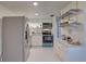 Bright kitchen featuring modern white cabinets, granite countertops, and stainless steel appliances at 1095 82Nd N Ter # 1095A, St Petersburg, FL 33702