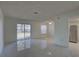 An open-concept living space with new tile floors and lots of natural light at 1095 82Nd N Ter # 1095A, St Petersburg, FL 33702