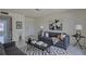 Bright living room with a gray sofa, accent rug, and modern decor at 1095 82Nd N Ter # 1095A, St Petersburg, FL 33702