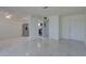 Bright open space with tiled floors, kitchen access, and neutral walls at 1095 82Nd N Ter # 1095A, St Petersburg, FL 33702