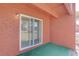 Enclosed brick patio with sliding glass door and green carpet at 1095 82Nd N Ter # 1095A, St Petersburg, FL 33702