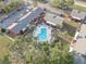 Aerial view showcasing the community pool and well-maintained exterior common areas, with shade trees, for residents at 1095 82Nd N Ter # 1095A, St Petersburg, FL 33702