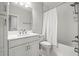 Neutral bathroom with modern faucet, white cabinets and shower with tub at 11014 Rustic Timber Loop, San Antonio, FL 33576