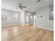 Bright primary bedroom featuring wood floors, tray ceiling, ceiling fan and natural light at 11014 Rustic Timber Loop, San Antonio, FL 33576