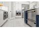 Kitchen with stainless steel double ovens, white cabinets, and sleek countertops at 11014 Rustic Timber Loop, San Antonio, FL 33576