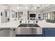 Close-up of the kitchen island featuring a stainless steel sink and modern faucet fixtures at 11014 Rustic Timber Loop, San Antonio, FL 33576
