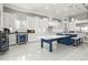 Modern kitchen with sleek white cabinetry, stainless steel appliances, and stylish blue island with seating at 11014 Rustic Timber Loop, San Antonio, FL 33576