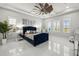 Spacious main bedroom with high ceilings, decorative ceiling fan, and plantation shutters at 11014 Rustic Timber Loop, San Antonio, FL 33576